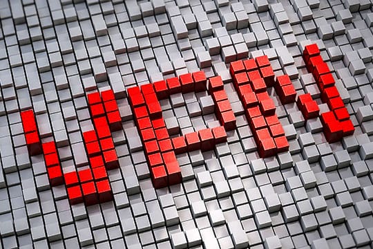 Red 3D block letters spelling "VPN" on a background of gray blocks.