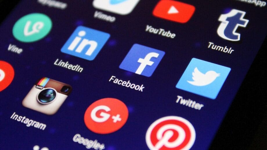 A smartphone screen displaying various social media app icons, including YouTube, Tumblr, LinkedIn, Facebook, Twitter, Instagram, Google+, and Pinterest.