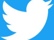 White Twitter bird logo on a blue background.