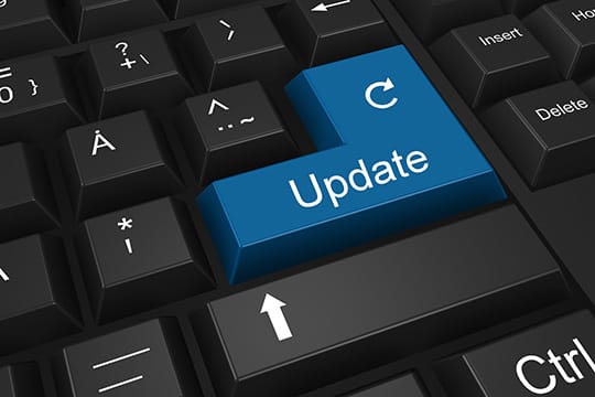 A keyboard with a large blue "Update" key featuring a circular arrow symbol.