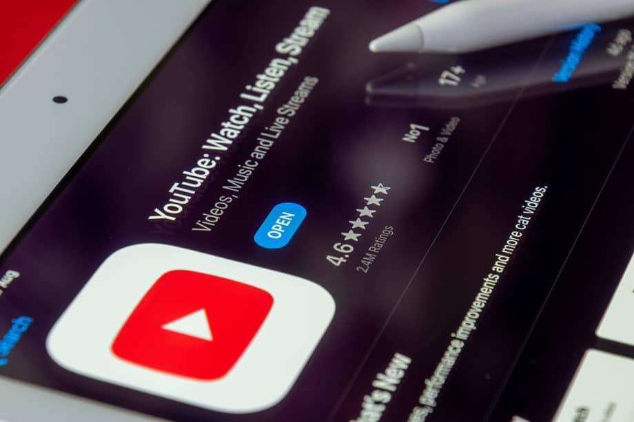 Close-up of a tablet screen displaying the YouTube app page in an app store, showing ratings and an Open button.