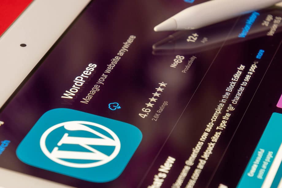 A wordpress app on an ipad with a pen on it.
