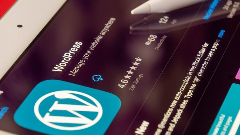A wordpress app on an ipad with a pen on it.