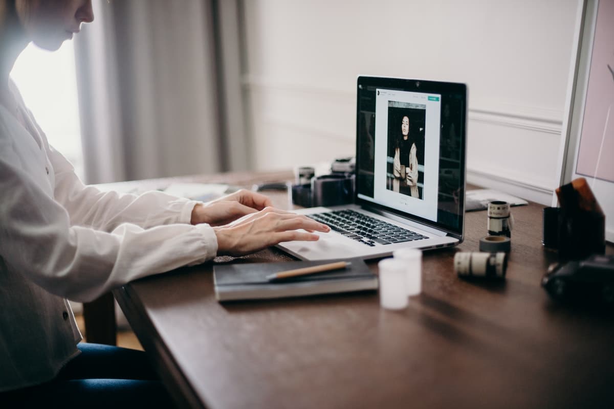 A woman working on her laptop at home.