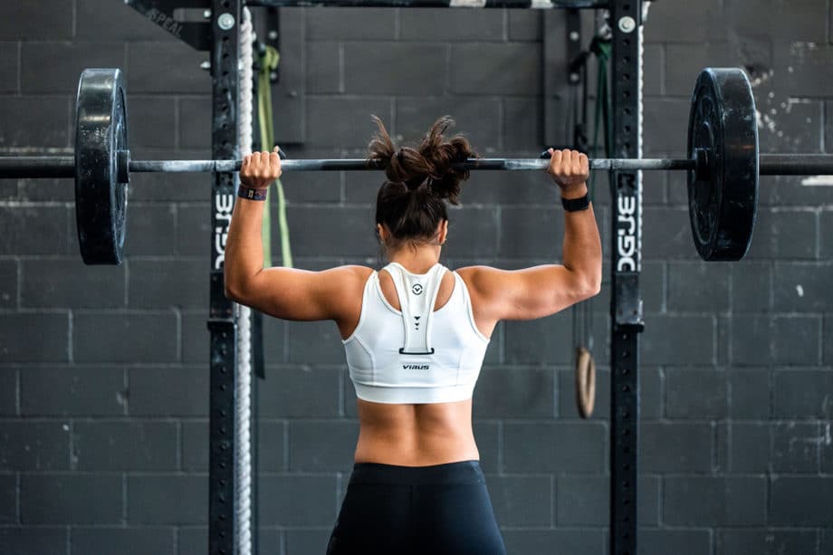 A woman lifting a barbell.