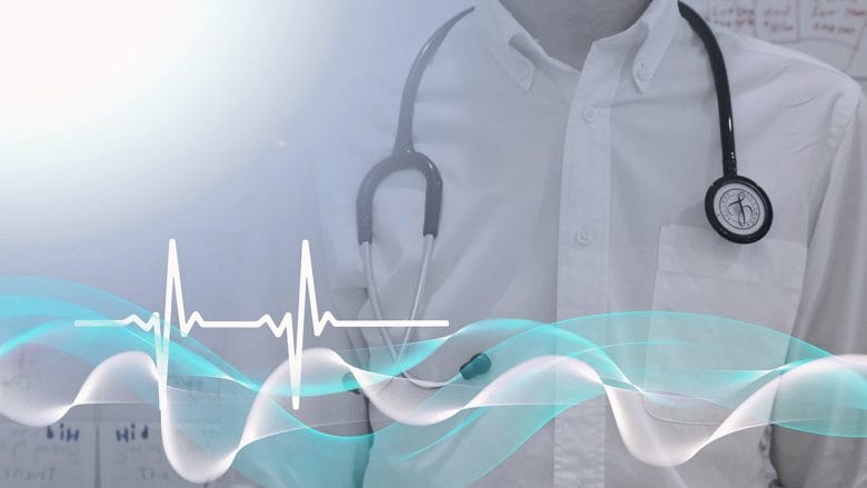 A man with a stethoscope in front of a white background.