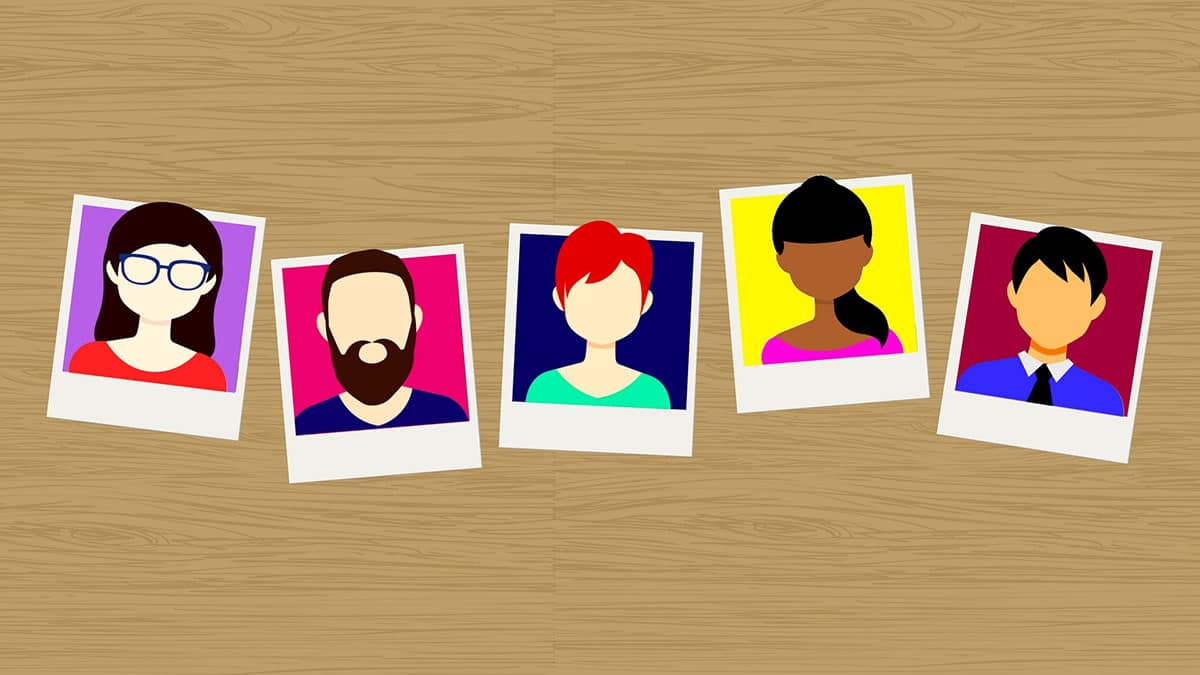 Illustration of five diverse, faceless portrait photos arranged diagonally on a wooden surface background.