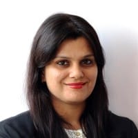 Vartika Kashyap, the author of this article, with long dark hair and a black blazer, smiling against a plain white background. Vartika Kashyap, the author of this article, with long dark hair and a black blazer, smiling against a plain white background.