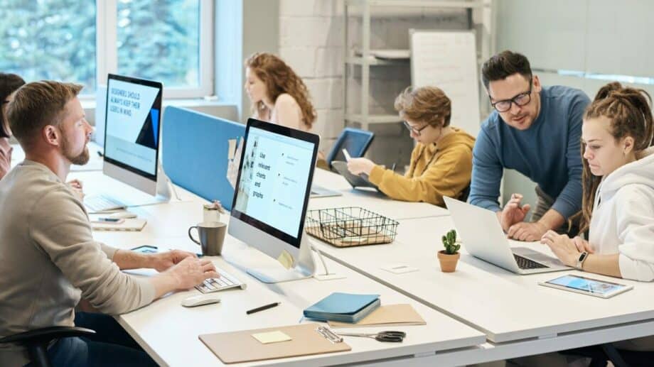 A group of people working on computers in an office.