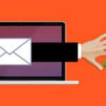 Illustration of a hand reaching from a laptop screen toward a credit card and cash, symbolizing online fraud or phishing.