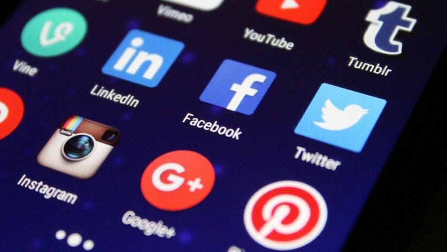 A smartphone screen displaying various social media app icons, including YouTube, Tumblr, LinkedIn, Facebook, Twitter, Instagram, Google+, and Pinterest.