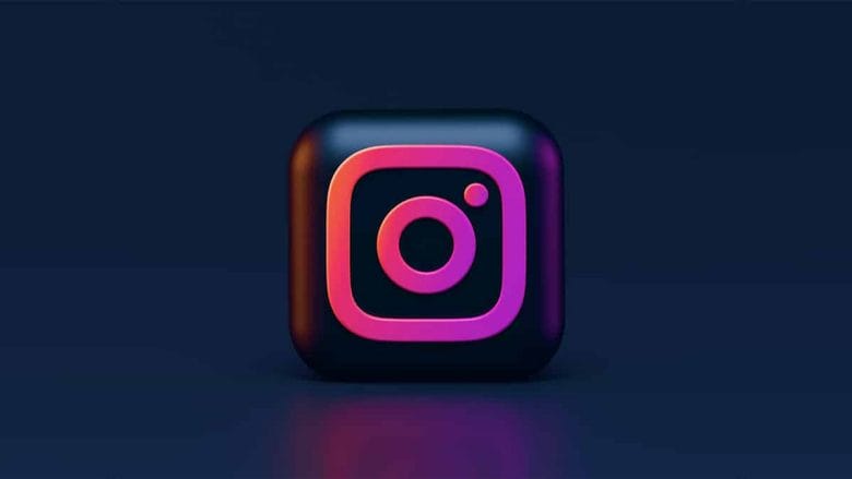 A 3D square icon with the Instagram logo in pink and orange gradient on a dark blue background.