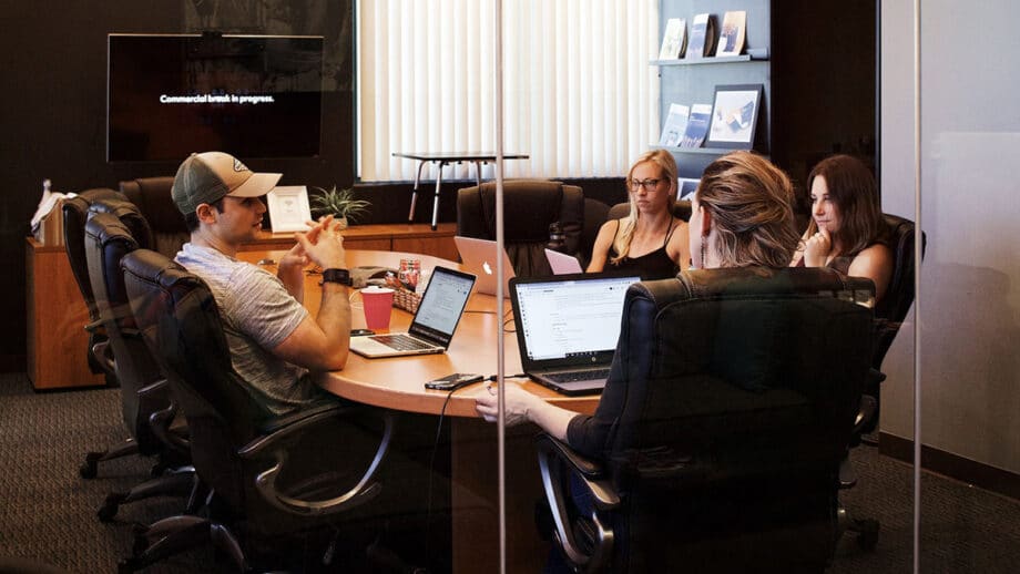 A group of people sitting around a conference table.