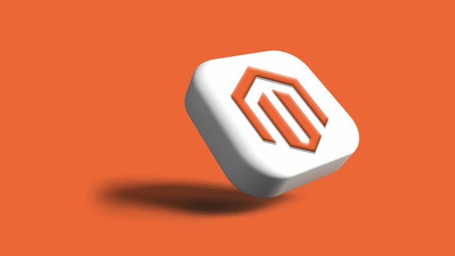 A white, rounded square button with an orange Magento logo is shown against an orange background. The button is slightly tilted and casting a shadow.