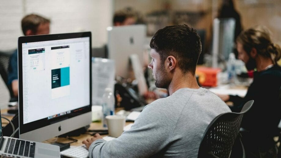 A man is working on a computer in an office.