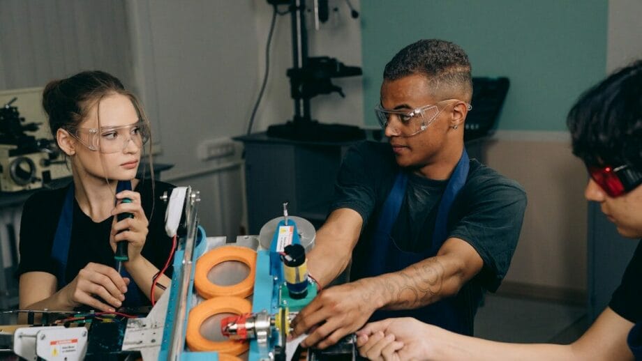 A group of young people working on electronics in a lab.