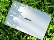 A white ACEMAGIC ‎AX15 Laptop laying in the grass.