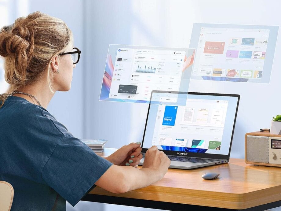 A woman sitting at a desk with an ACEMAGIC ‎AX15 Laptop in front of her.