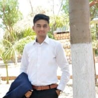 Nikunj Sharma, the author of this article, in a suit standing next to a tree. Nikunj Sharma, the author of this article, in a suit standing next to a tree.