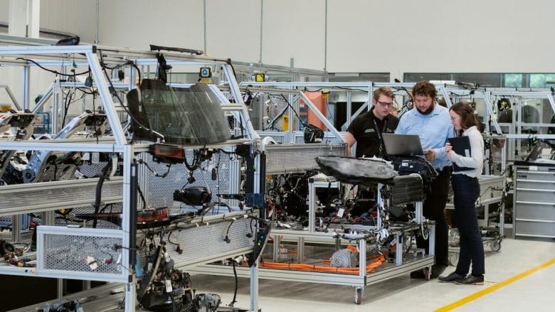 A group of people working in a manufacturing unit of a factory.