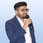 Mayank Patel, the author of this article, in glasses is holding a microphone.