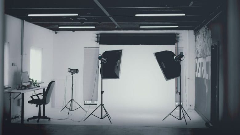 A photo studio with lights and a desk.