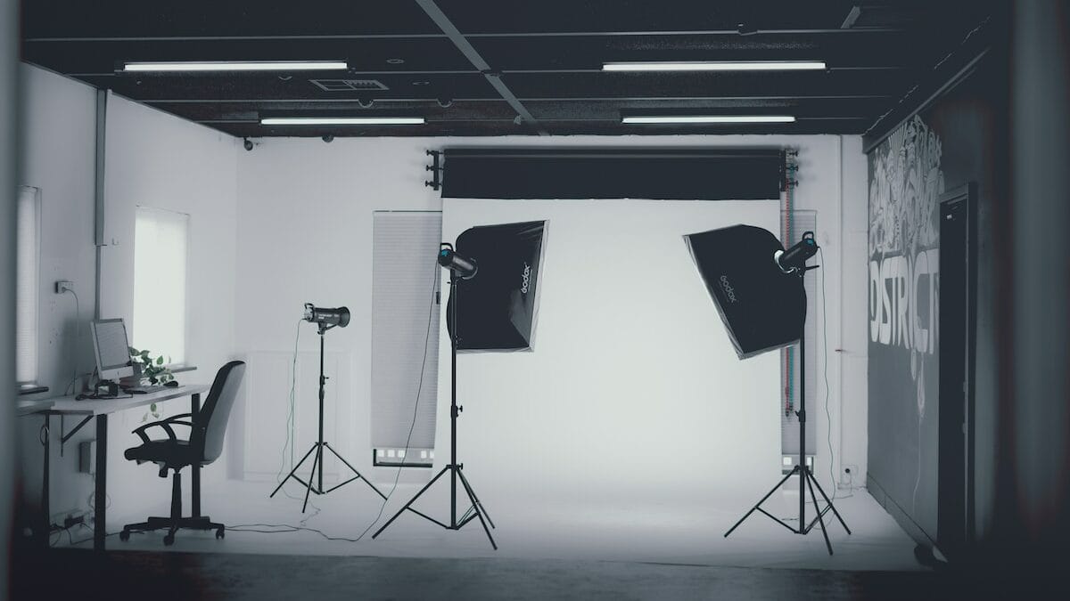 A photo studio with lights and a desk.