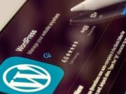 A wordpress app on an ipad with a pen on it.