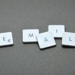 Five keyboard keys arranged to spell EMAIL on a gray surface.