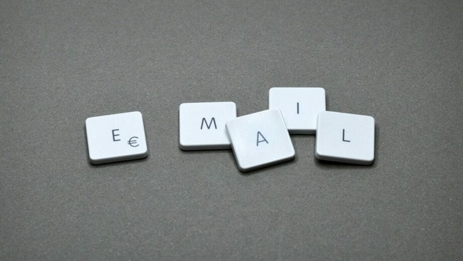 Five keyboard keys arranged to spell EMAIL on a gray surface.