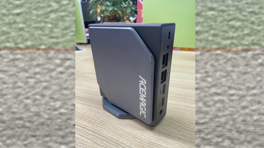 An ACEMAGIC S1 Mini PC sitting on top of a wooden table.