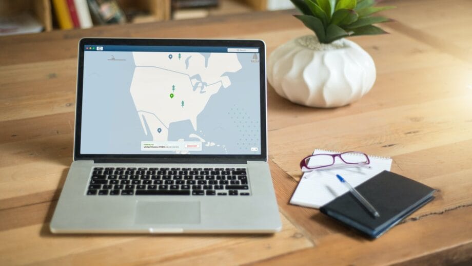 A laptop with a map on it on a wooden table.