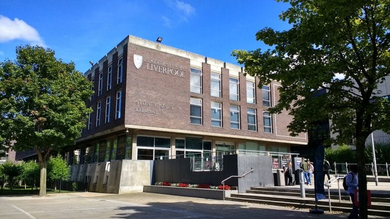 The Liverpool University building with people walking in front of it.