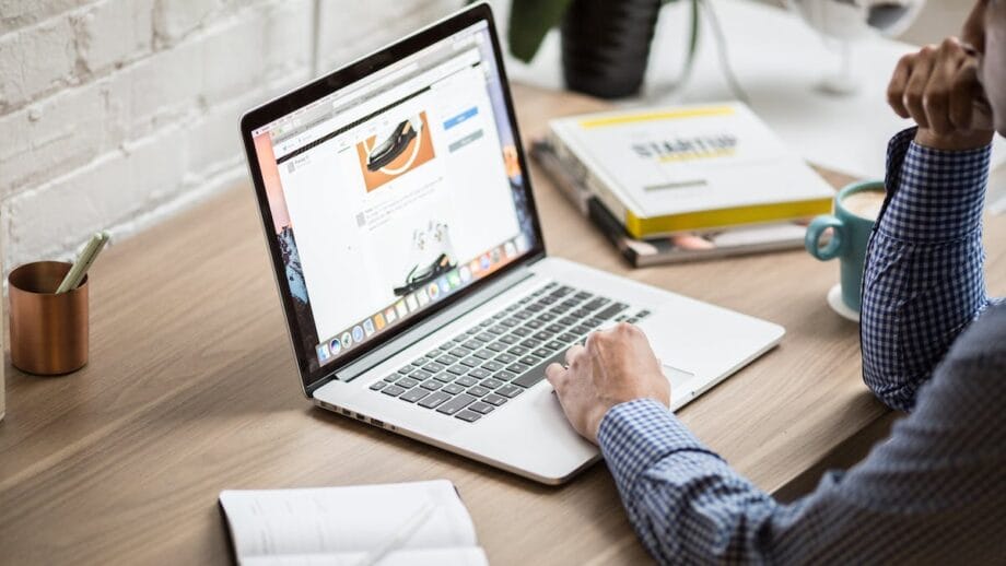 A man working on a laptop at a desk.