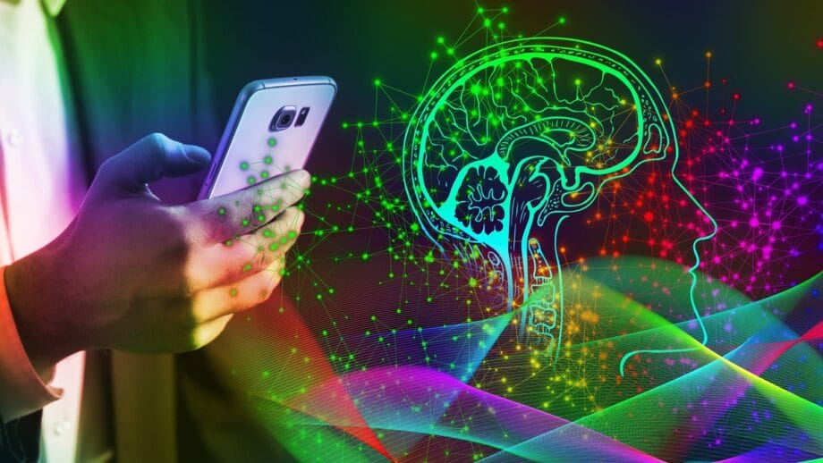 Person holding a smartphone, with a digital illustration of a brain and a head profile surrounded by colorful neural network lines, symbolizing the intersection of technology and artificial intelligence.