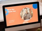 Computer monitor displaying a slide titled "What Our Clients Say" with a portrait of a man identified as Alan Mercey, Marketing Head.