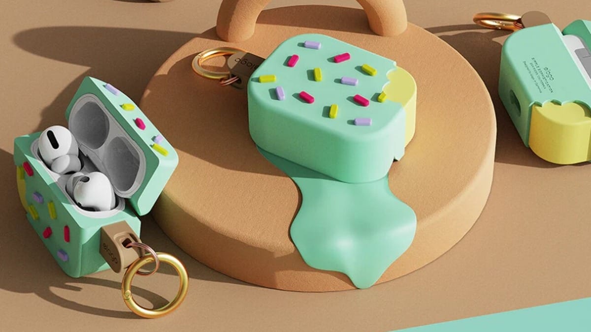 AirPods Pro case designed to look like a melting ice cream bar with colorful sprinkles and a keyring attachment, placed on a beige platform.