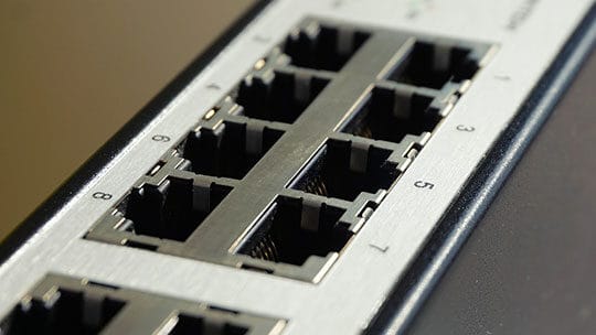 Close-up of an Ethernet switch showing multiple RJ-45 ports labeled with numbers.