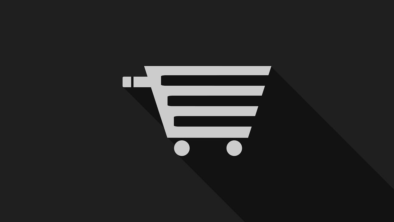 A gray shopping cart icon on a black background with a long shadow extending to the right.