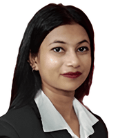 Sukanya Dey, the author of this article, with long black hair in a black blazer and white shirt, facing forward, against a plain white background.