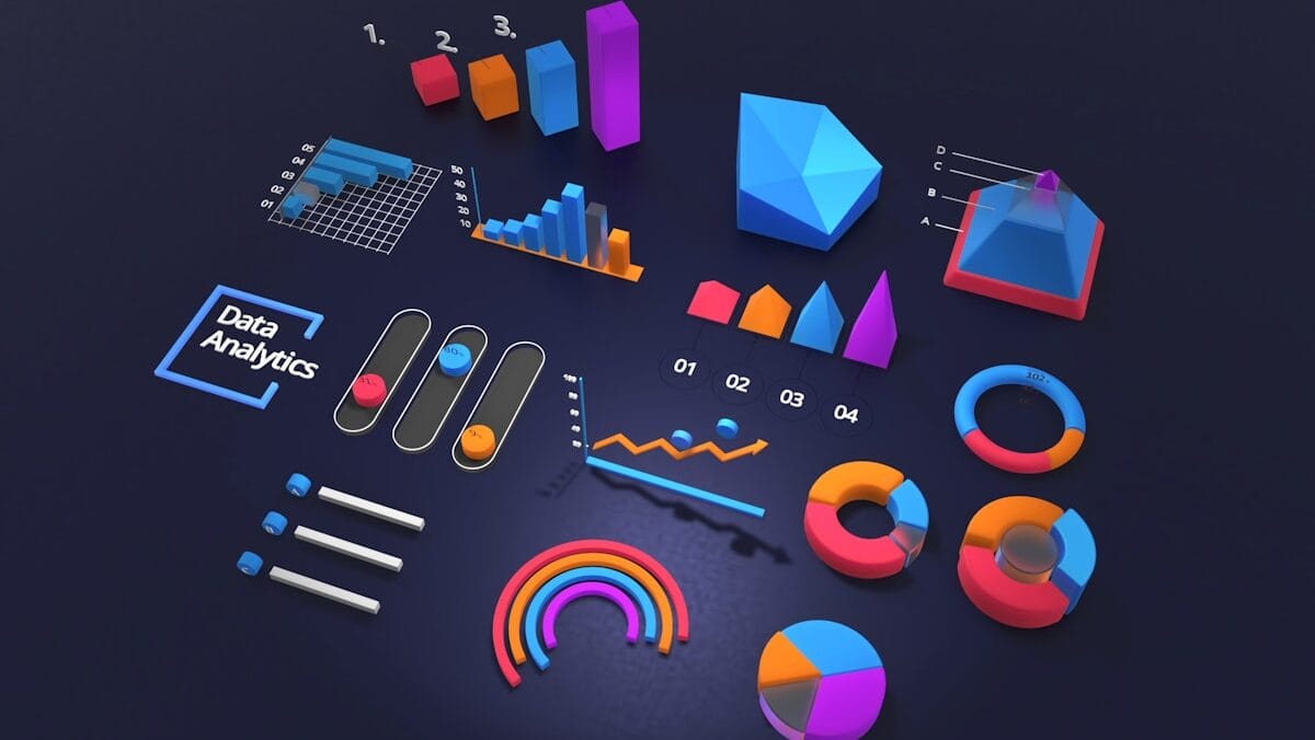 Aerial view of various colorful 3D charts and graphs, including bar, line, pie, and pyramid shapes, labeled with numbers and "Data Analytics" on a dark background.