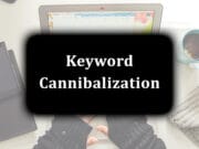 Laptop, smartphone, and coffee on a desk with "Keyword Cannibalization" text overlay.