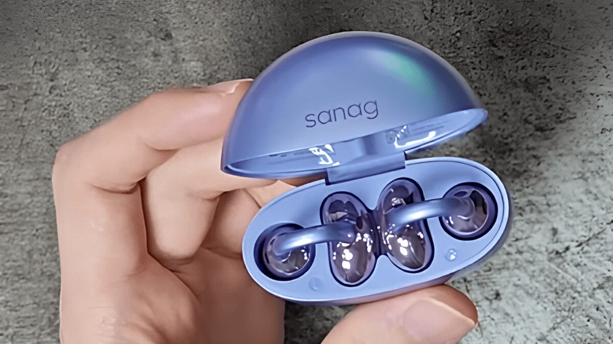 A hand holding an open blue case with two Sanag S6S Open Ear Clip Earphones inside.