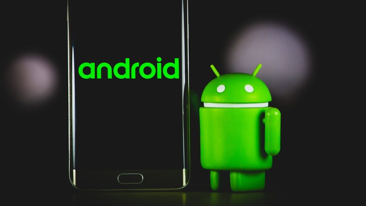 A smartphone displaying "android" next to a small green Android figure on a dark background.