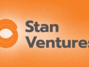 Stan Ventures logo with an orange circular design and gray text on a textured orange background.