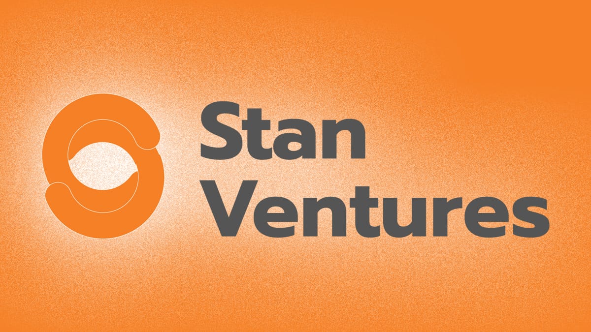 Stan Ventures logo with an orange circular design and gray text on a textured orange background.