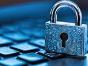 A silver padlock sits on a computer keyboard, symbolizing cybersecurity and data protection.