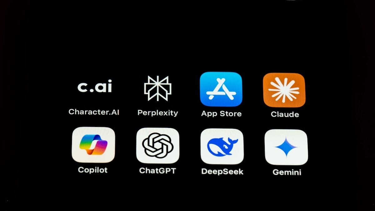 Smartphone screen with eight app icons, including Character.AI, Perplexity, App Store, Claude, Copilot, ChatGPT, DeepSeek, and Gemini.