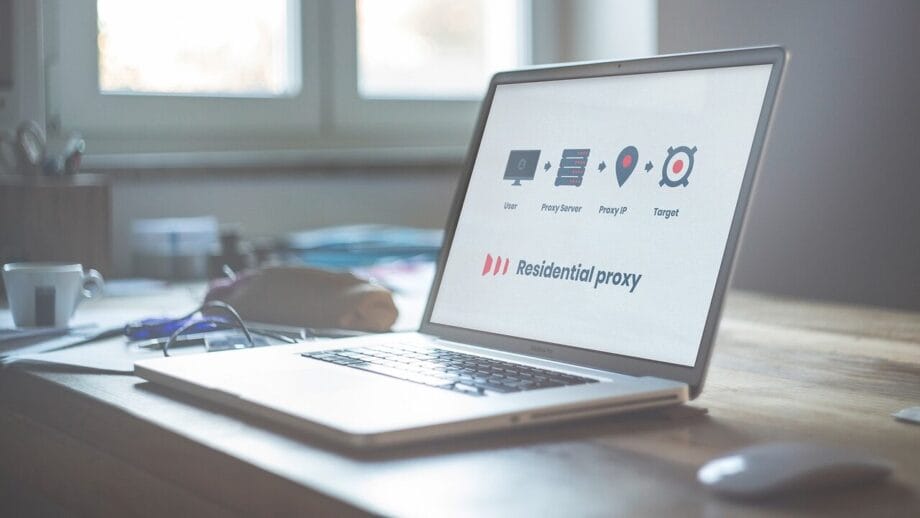 Open laptop on a wooden desk displaying a software interface labeled Residential proxy.