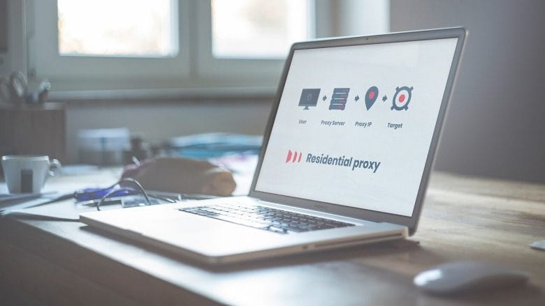 Open laptop on a wooden desk displaying a software interface labeled Residential proxy.
